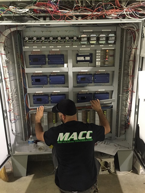 Technician performing maintenance on a BAS system