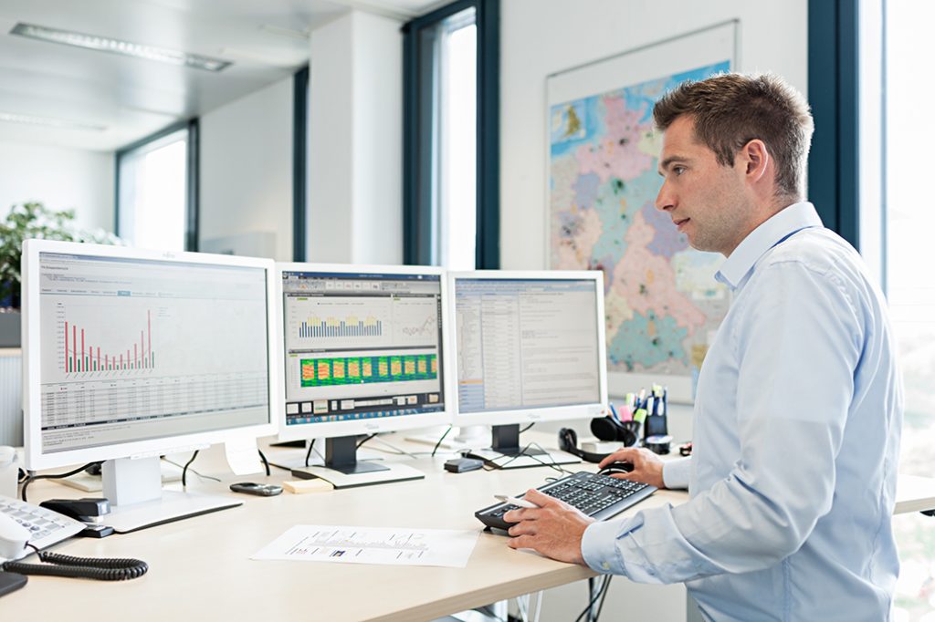 Facility manager monitoring energy consumption on a computer